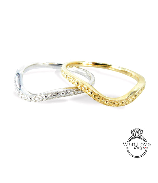 Two ornate rings, one silver and one gold, are displayed against a white background.