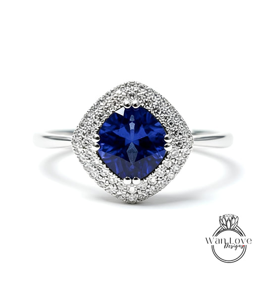 A stunning blue sapphire ring with a halo of sparkling diamonds set in a silver band.