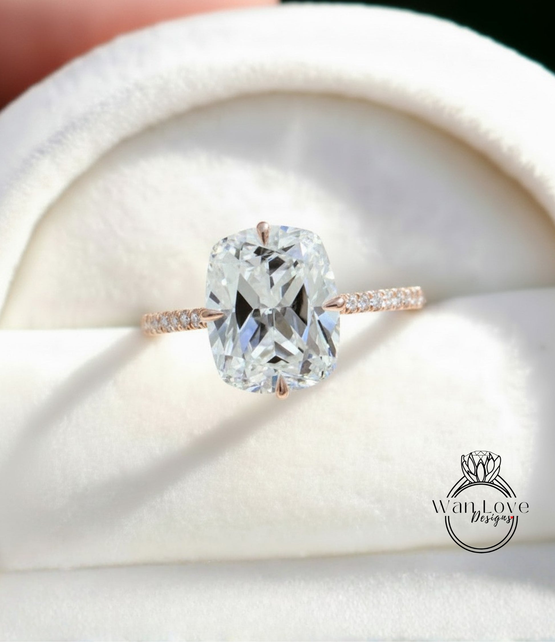 A large, clear diamond engagement ring with a solitaire diamond set in a rose gold band, displayed in a white box.