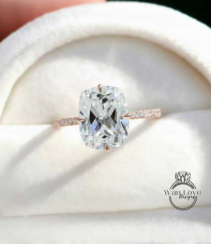 A large, clear diamond engagement ring with a solitaire diamond set in a rose gold band, displayed in a white box.