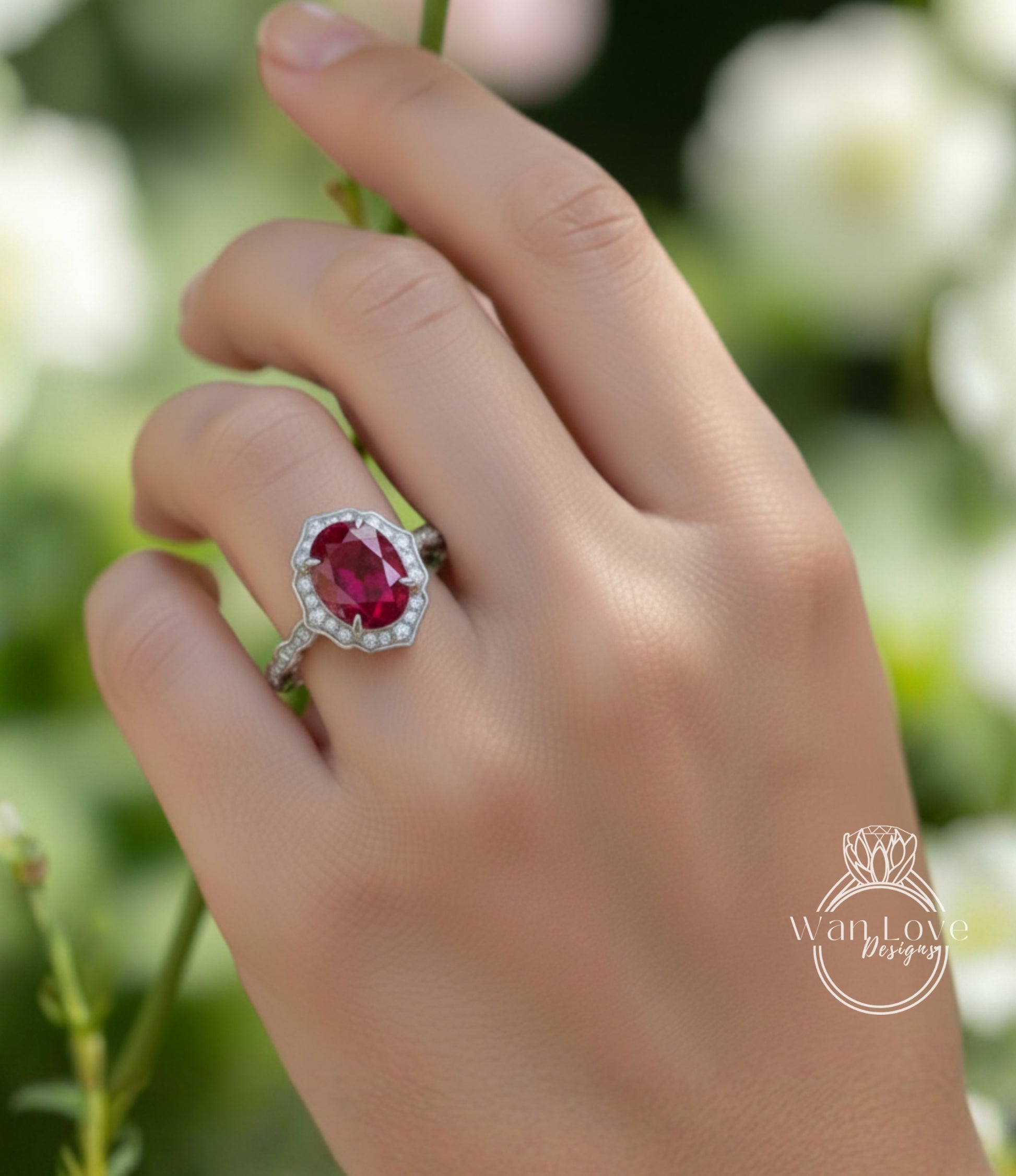 A close-up of a hand wearing a ring with a large, deep red gemstone, likely a ruby, set in a halo of smaller diamonds.