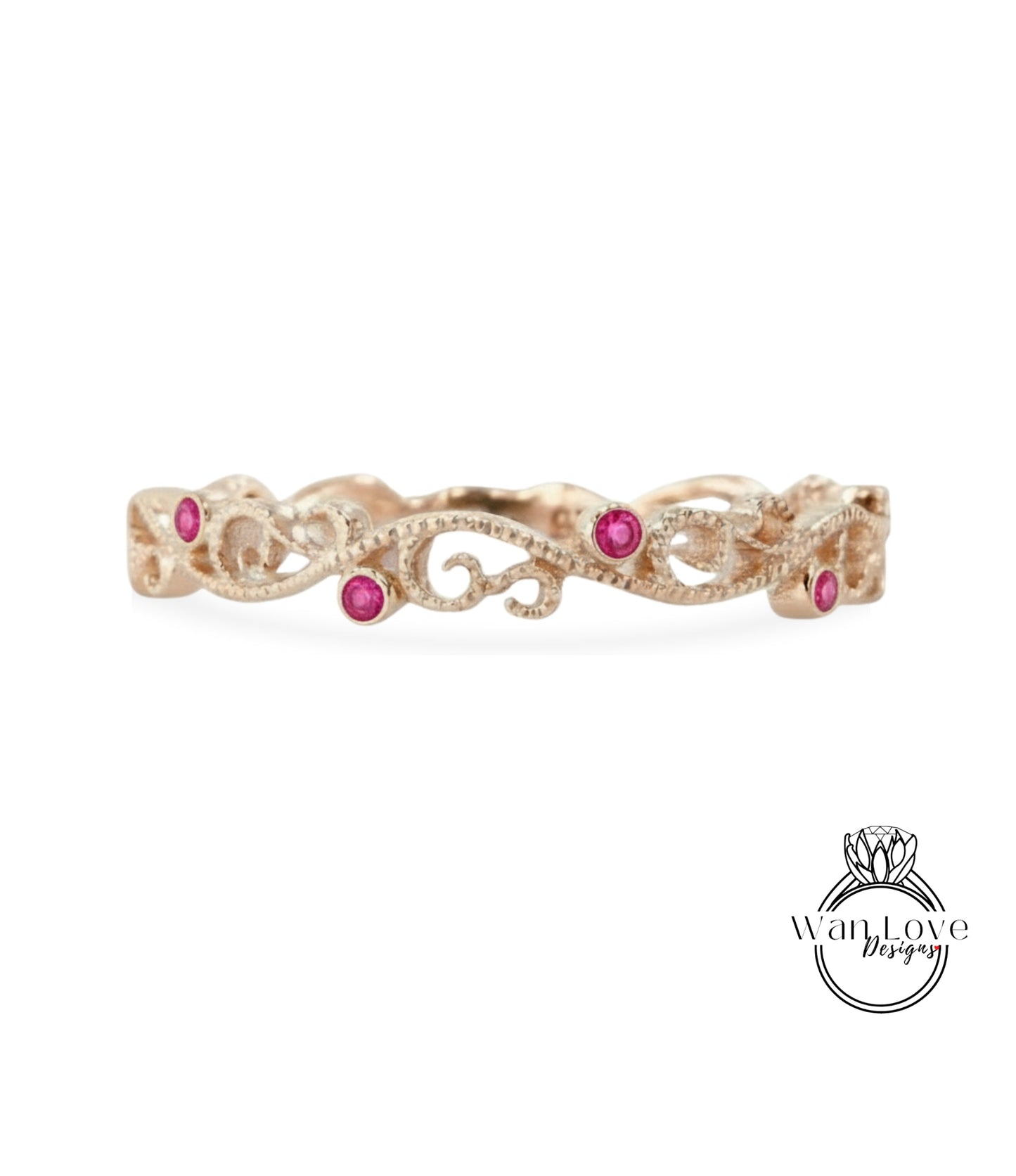 A delicate gold ring with a floral design and small pink gemstones.