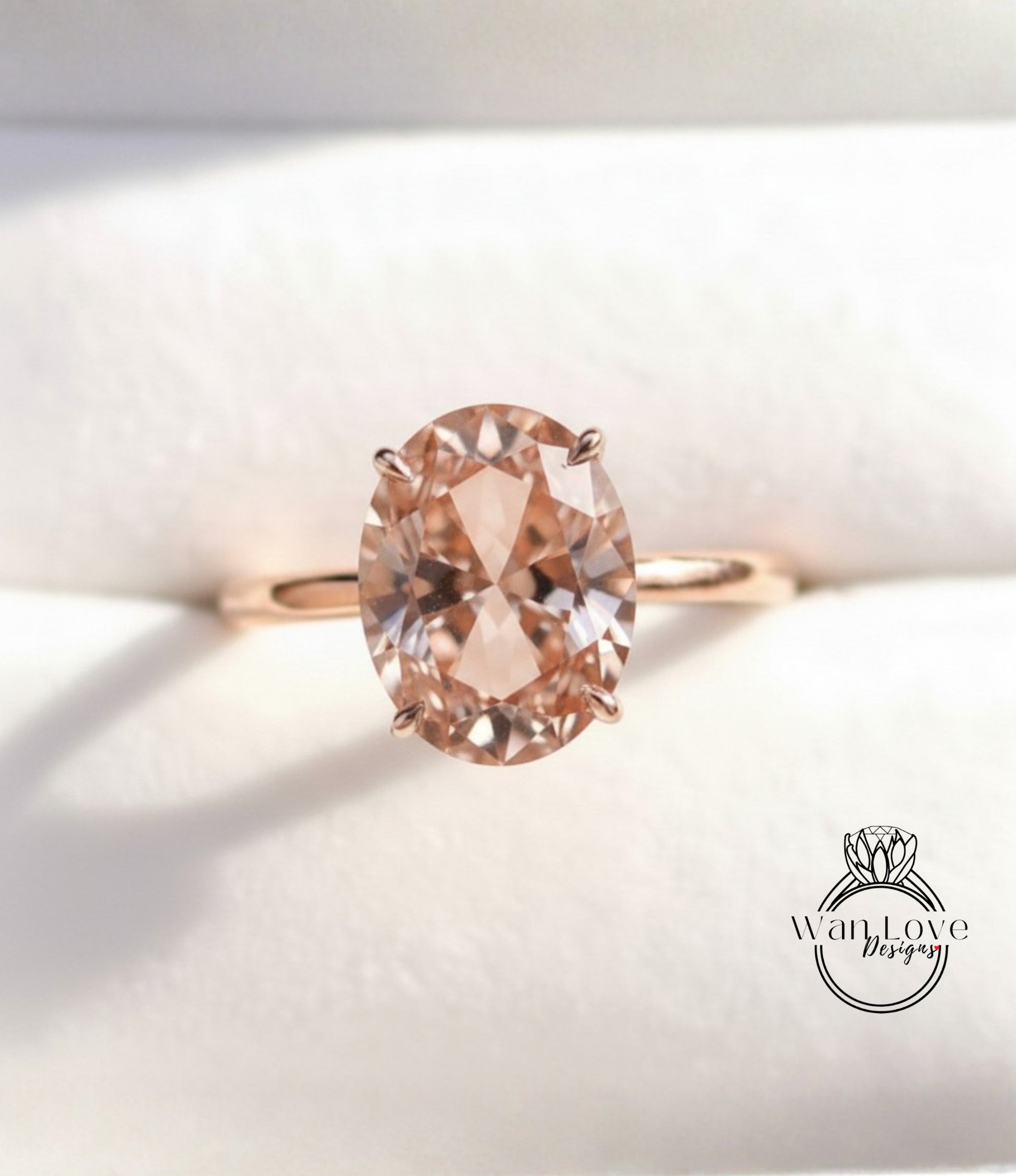 A close-up image of a gold ring with a large oval-shaped gemstone, possibly a diamond, set in the center of the band.