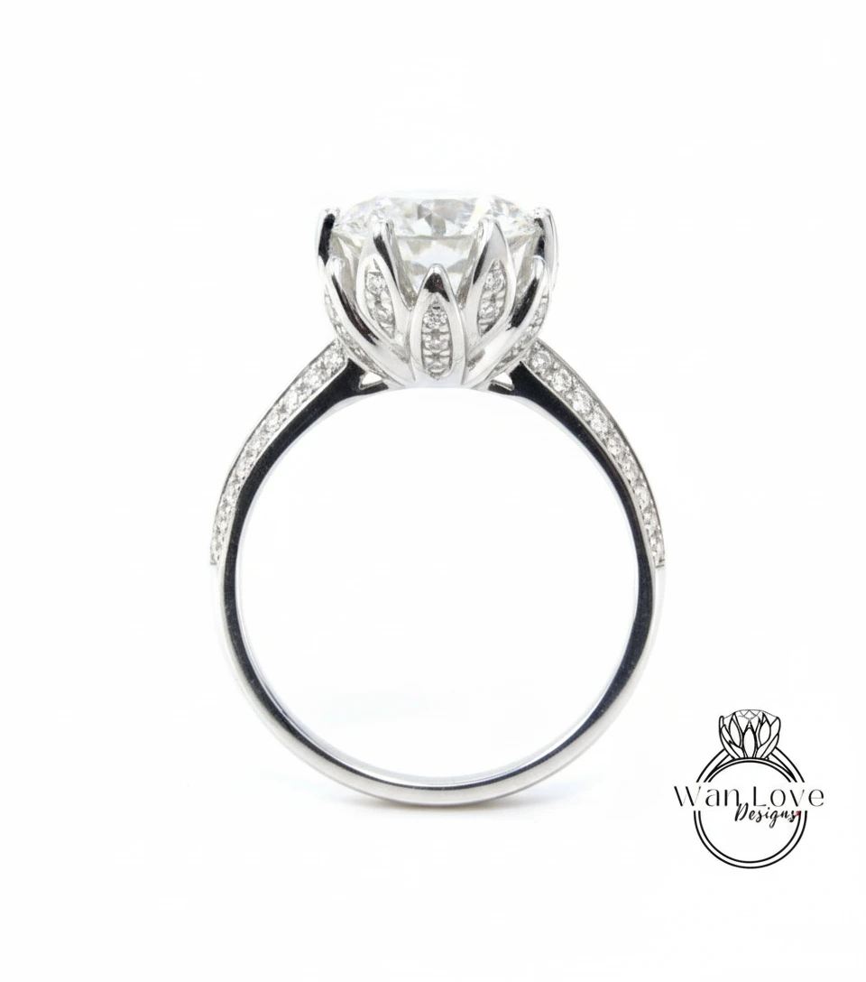 A silver engagement ring with a large, round diamond set in a flower-like design, surrounded by smaller diamonds.