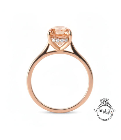 A rose gold engagement ring with a large, round-cut diamond set in the center, surrounded by smaller diamonds.