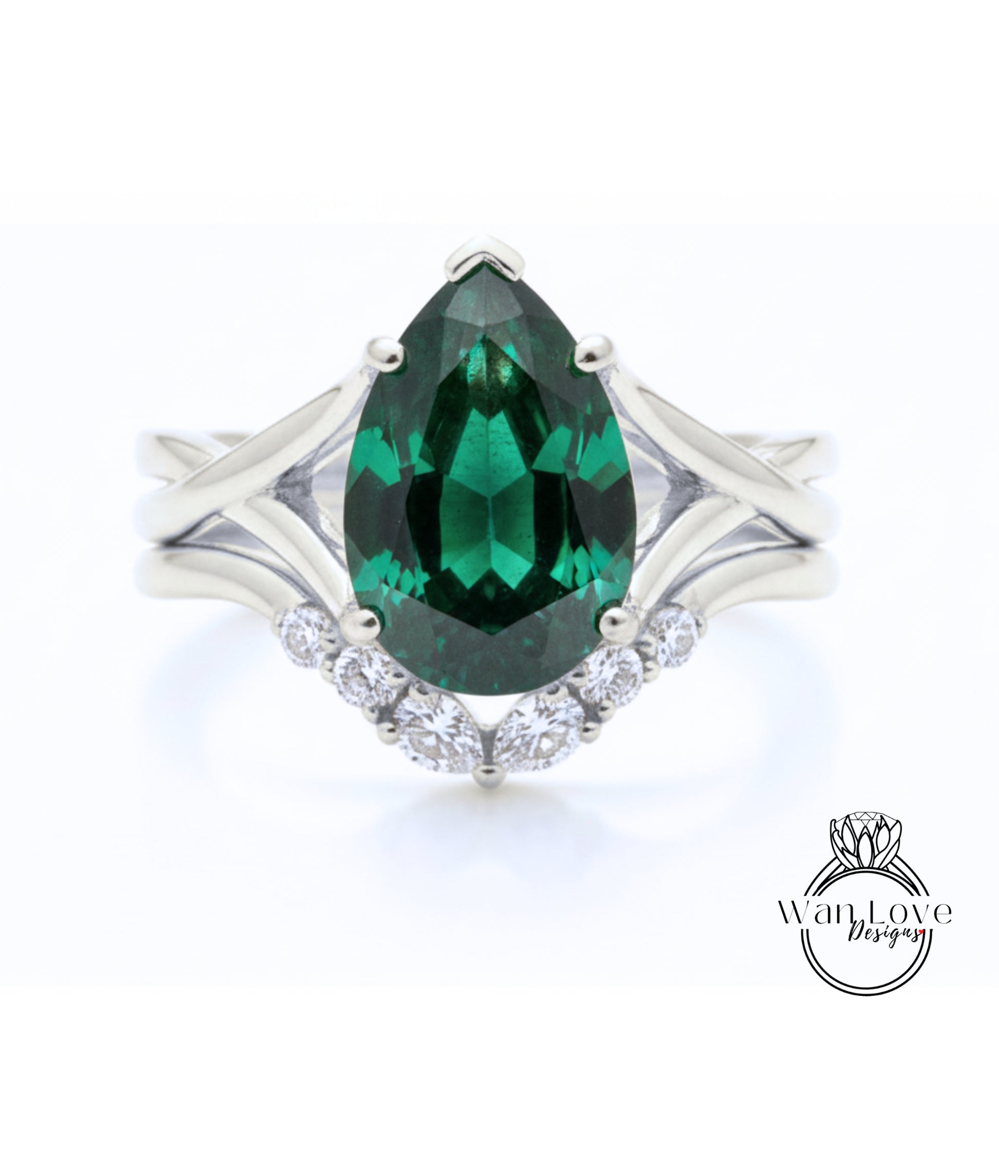 A silver ring with a large, green gemstone at the center, surrounded by smaller diamonds.