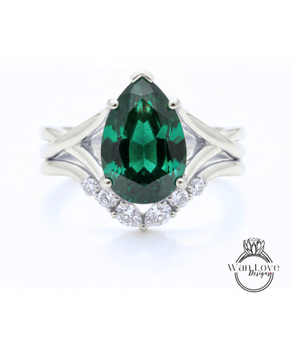 A silver ring with a large, green gemstone at the center, surrounded by smaller diamonds.