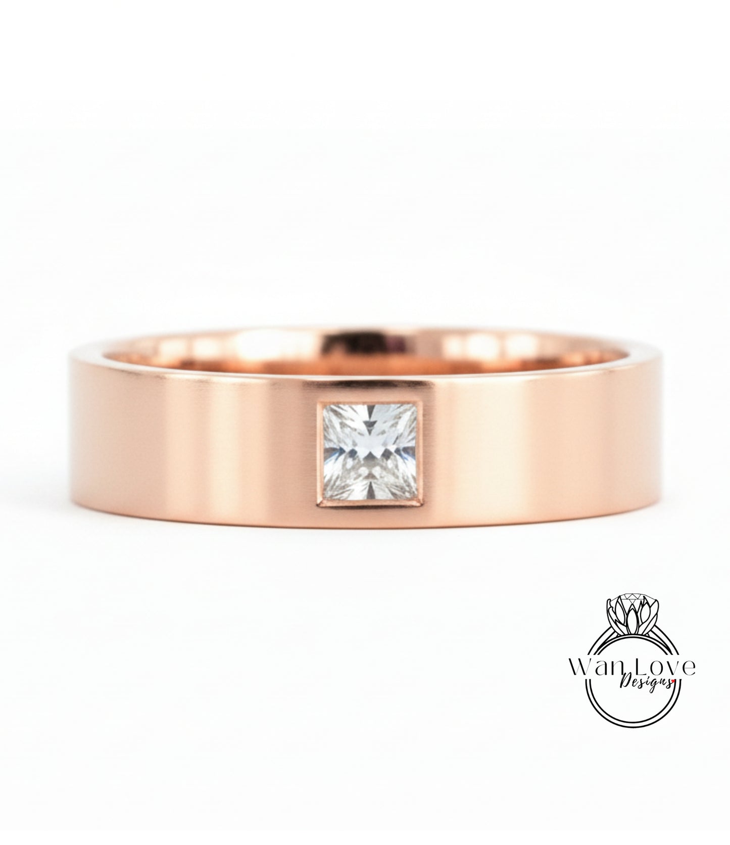 A rose gold ring with a large diamond set in the center.