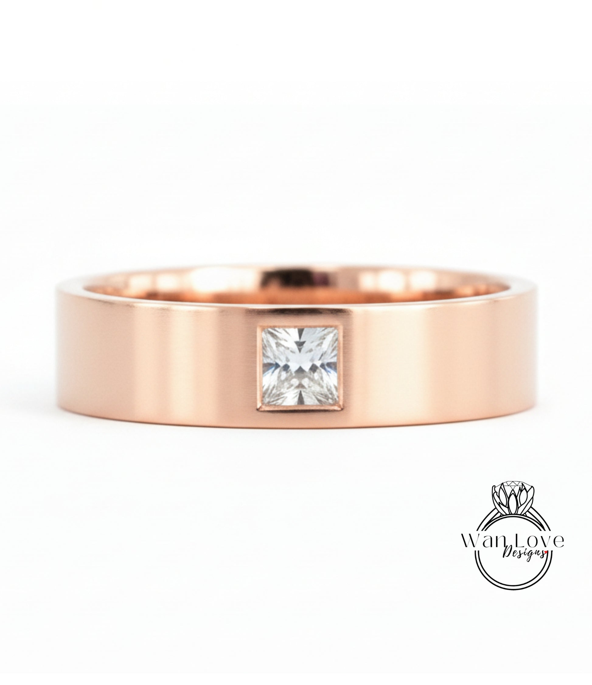 A rose gold ring with a large diamond set in the center.