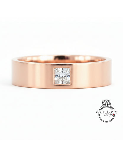 A rose gold ring with a large diamond set in the center.