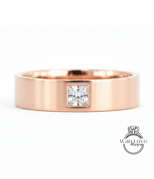 A rose gold ring with a large diamond set in the center.