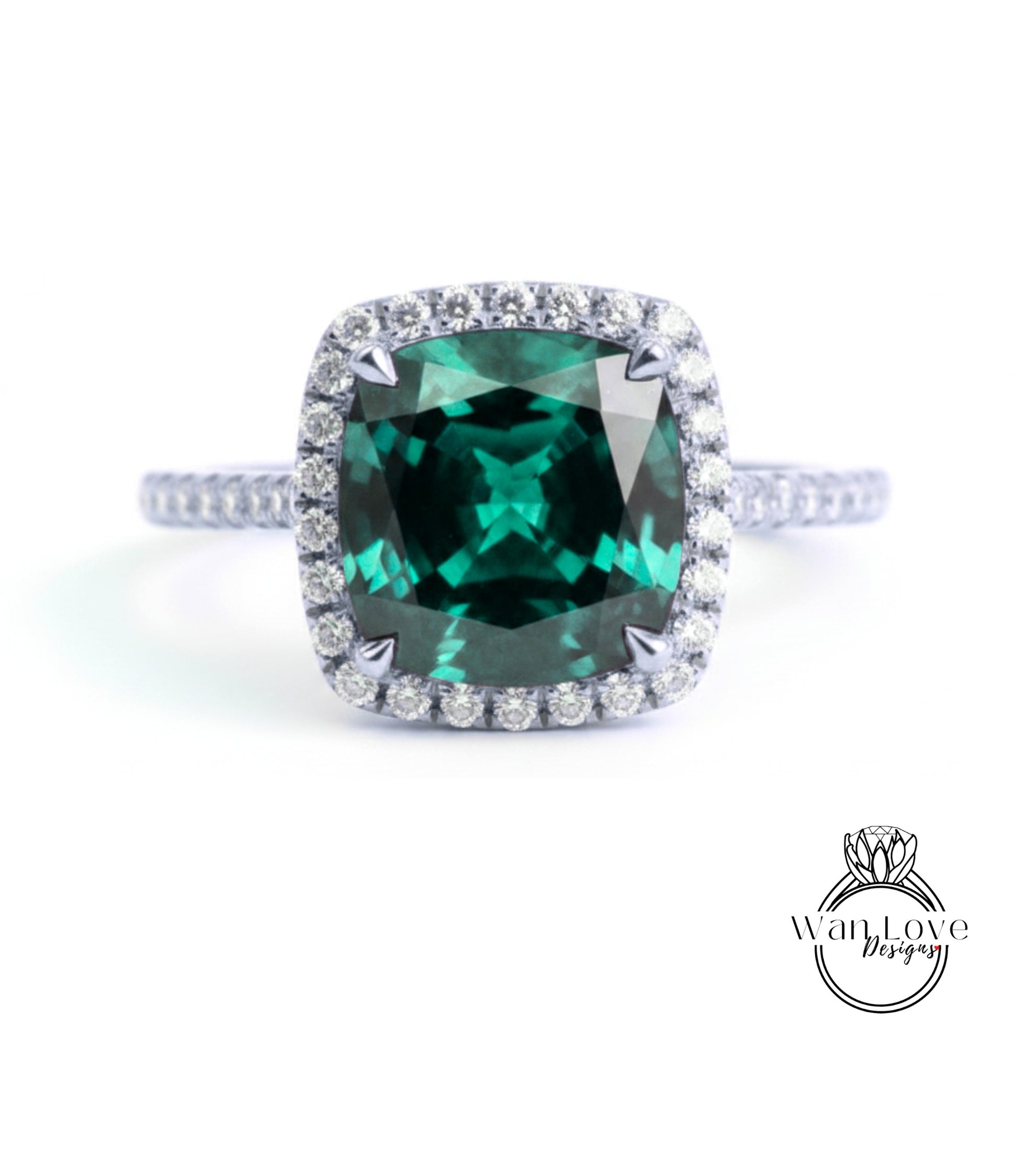 A stunning ring featuring a large, square-cut green gemstone surrounded by a halo of smaller diamonds set in a silver band.