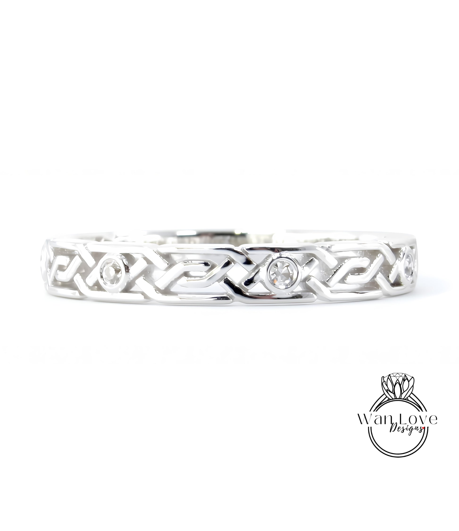 A silver band with an intricate Celtic knot design and two small diamonds set in the center.