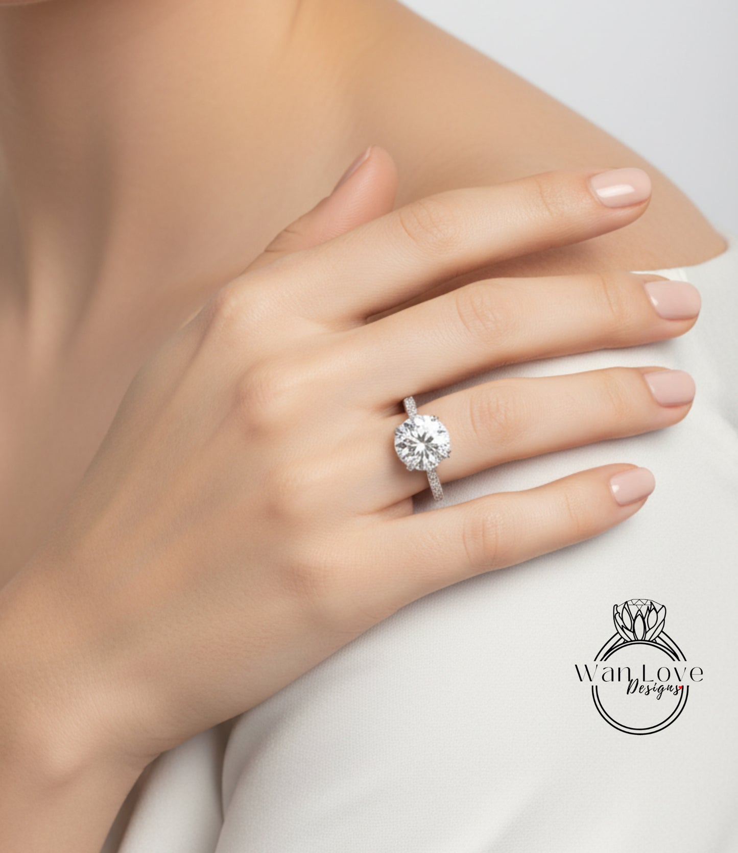 A close-up of a person's hand wearing a large diamond engagement ring.