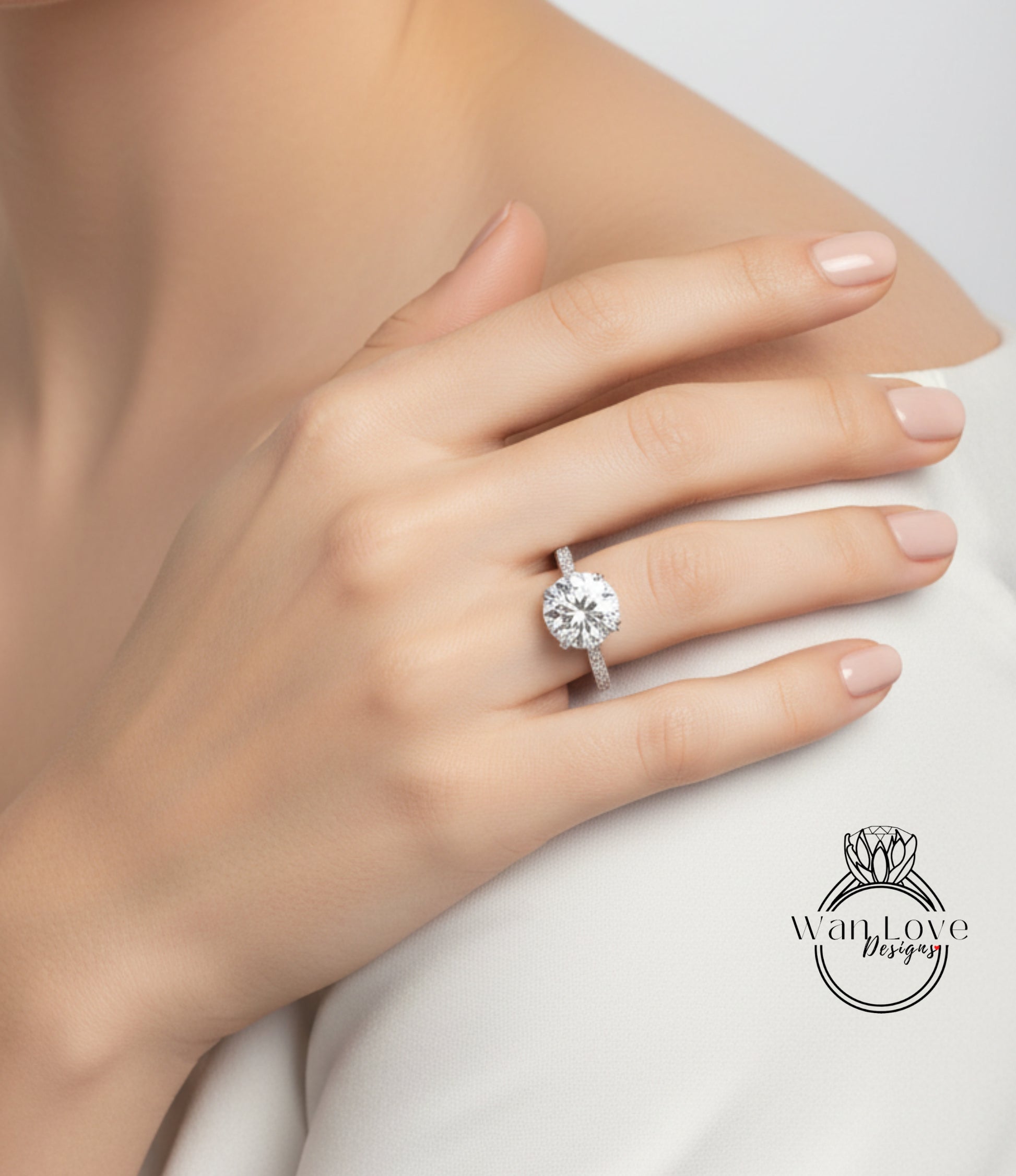 A close-up of a person's hand wearing a large diamond engagement ring.