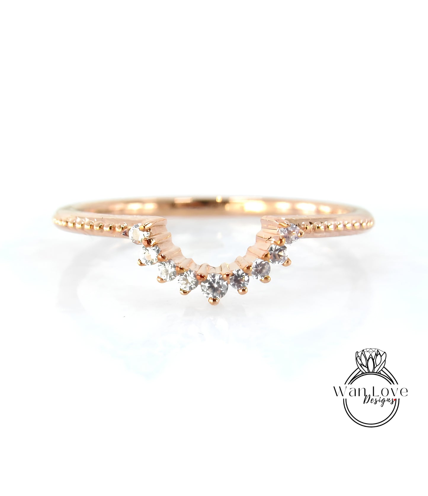 A rose gold ring with a diamond-encrusted band and a row of small diamonds set in the center.