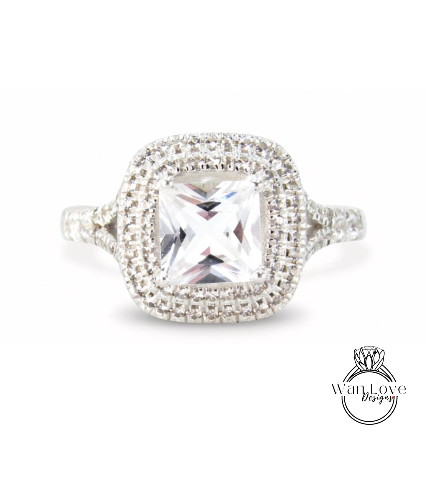 A diamond ring with a large central gemstone surrounded by smaller diamonds set in a halo of smaller diamonds.