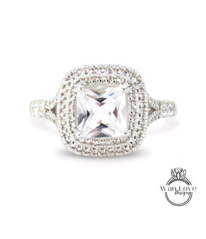 A diamond ring with a large central gemstone surrounded by smaller diamonds set in a halo of smaller diamonds.
