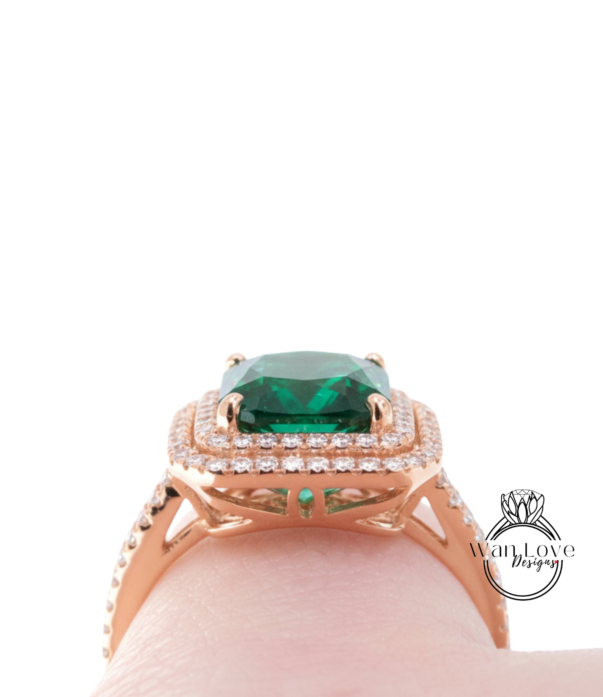 A close-up view of a gold ring with a large, square-cut green gemstone set in a halo of smaller diamonds.