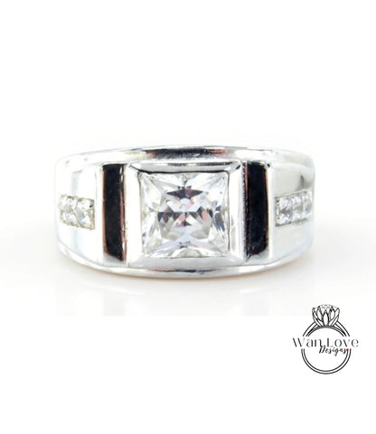A silver ring with a large, clear gemstone in the center.