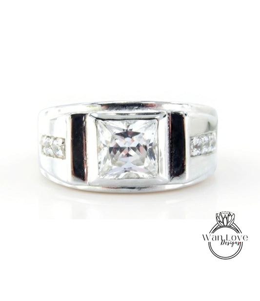 A silver ring with a large, clear gemstone in the center.