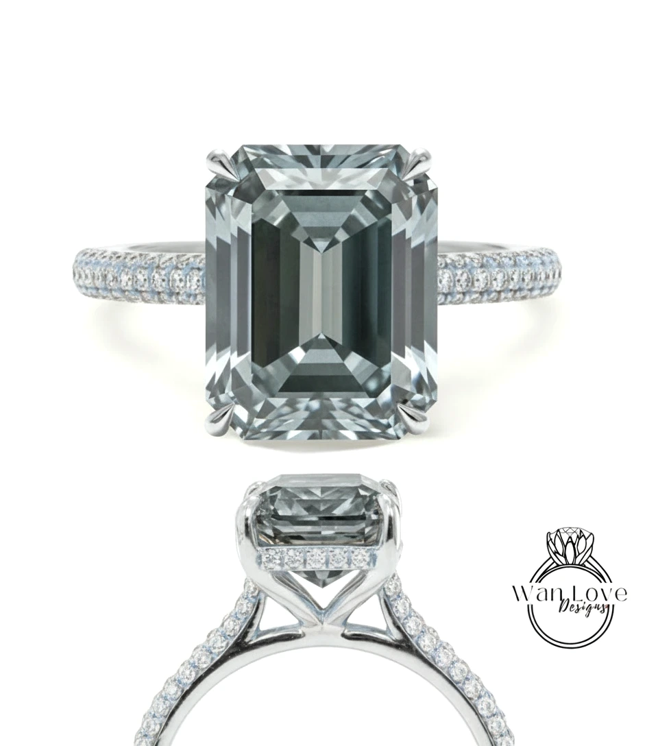 A stunning diamond engagement ring with a large, rectangular-shaped diamond set in a silver band adorned with small diamonds.