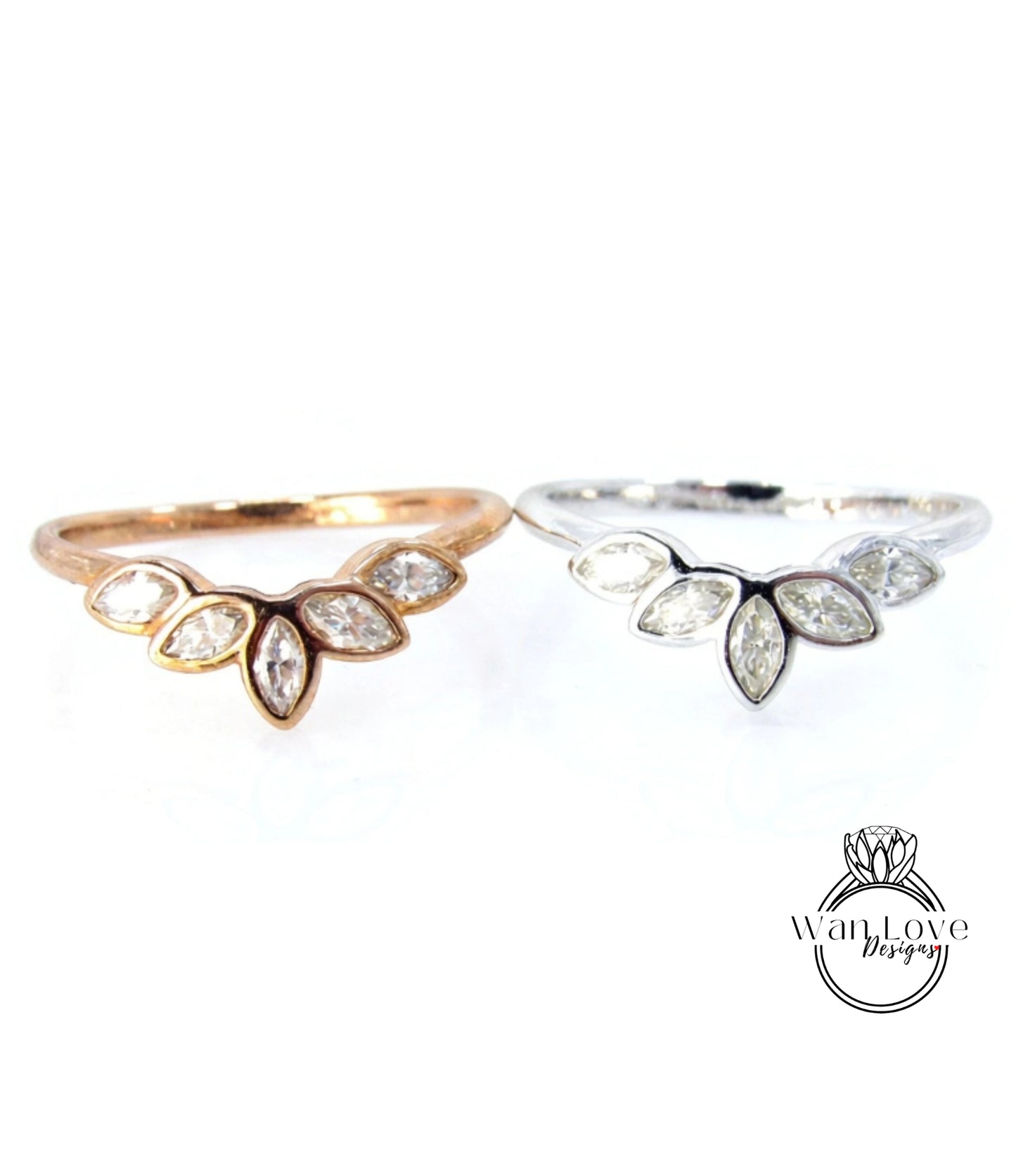 two rings, one with a gold band and the other with a silver band, both featuring a leaf-shaped diamond design.