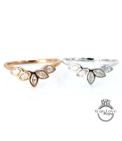 two rings, one with a gold band and the other with a silver band, both featuring a leaf-shaped diamond design.
