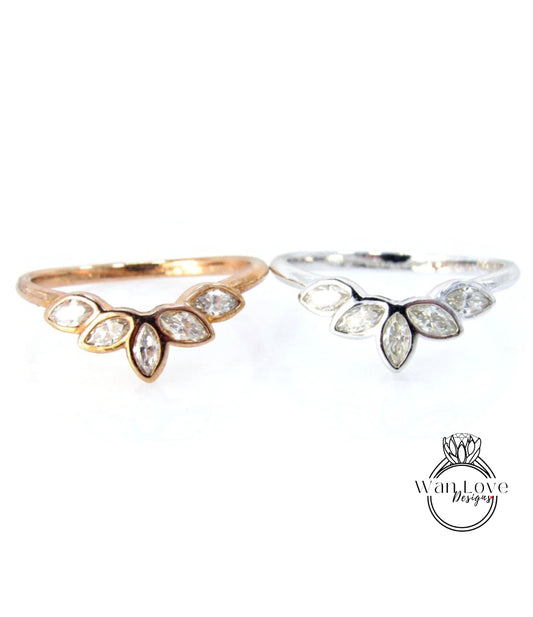 two rings, one with a gold band and the other with a silver band, both featuring a leaf-shaped diamond design.