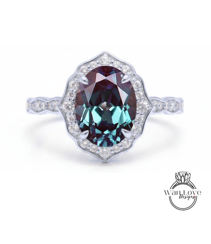 A stunning ring featuring a large oval-shaped gemstone surrounded by a halo of smaller diamonds, set in a silver band.