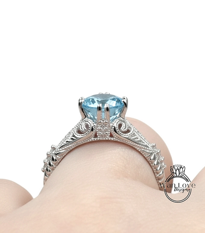 A close-up view of a silver engagement ring with a blue gemstone, showcasing the intricate design and craftsmanship.