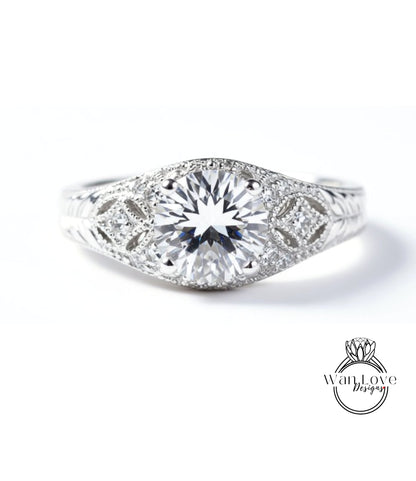 A close-up view of a diamond engagement ring with a large central diamond surrounded by smaller diamonds and intricate metalwork.