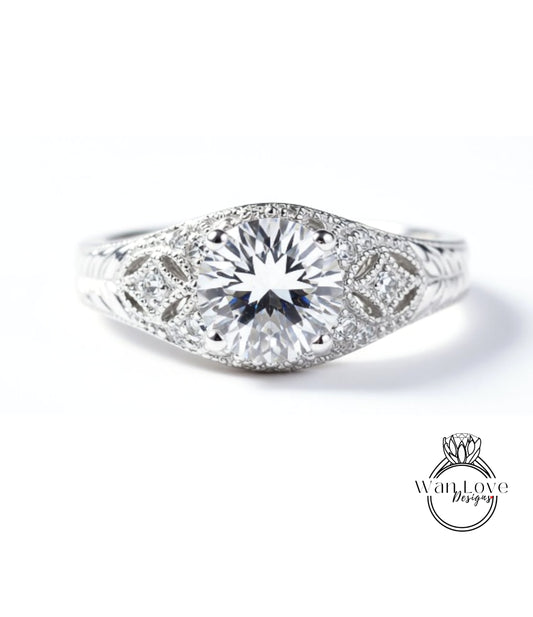 A close-up view of a diamond engagement ring with a large central diamond surrounded by smaller diamonds and intricate metalwork.