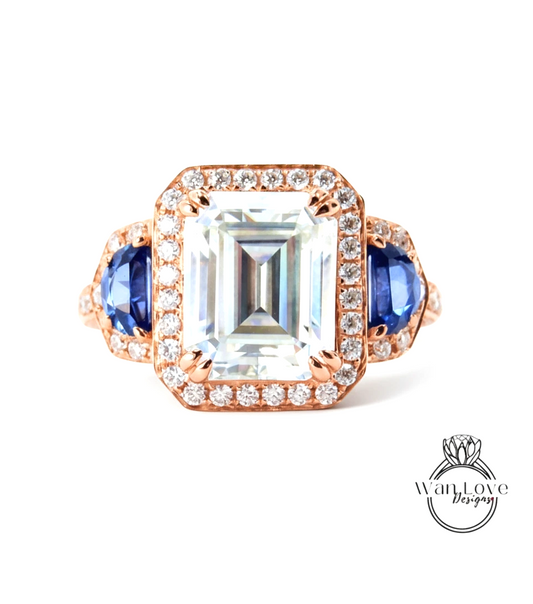 A large, clear gemstone ring with a halo of smaller diamonds around the center stone.