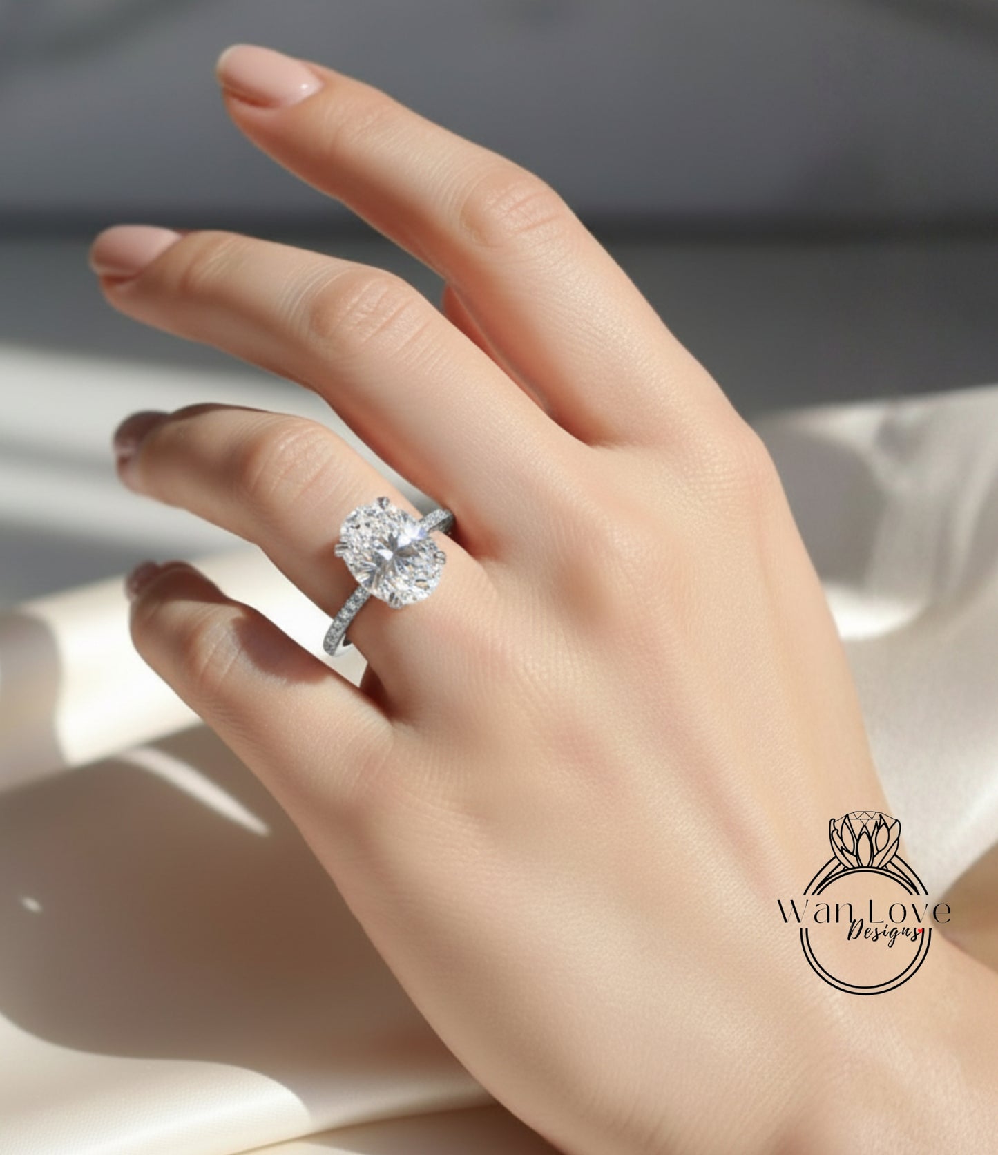 A close-up of a hand wearing a diamond engagement ring, with the ring's diamond visible.