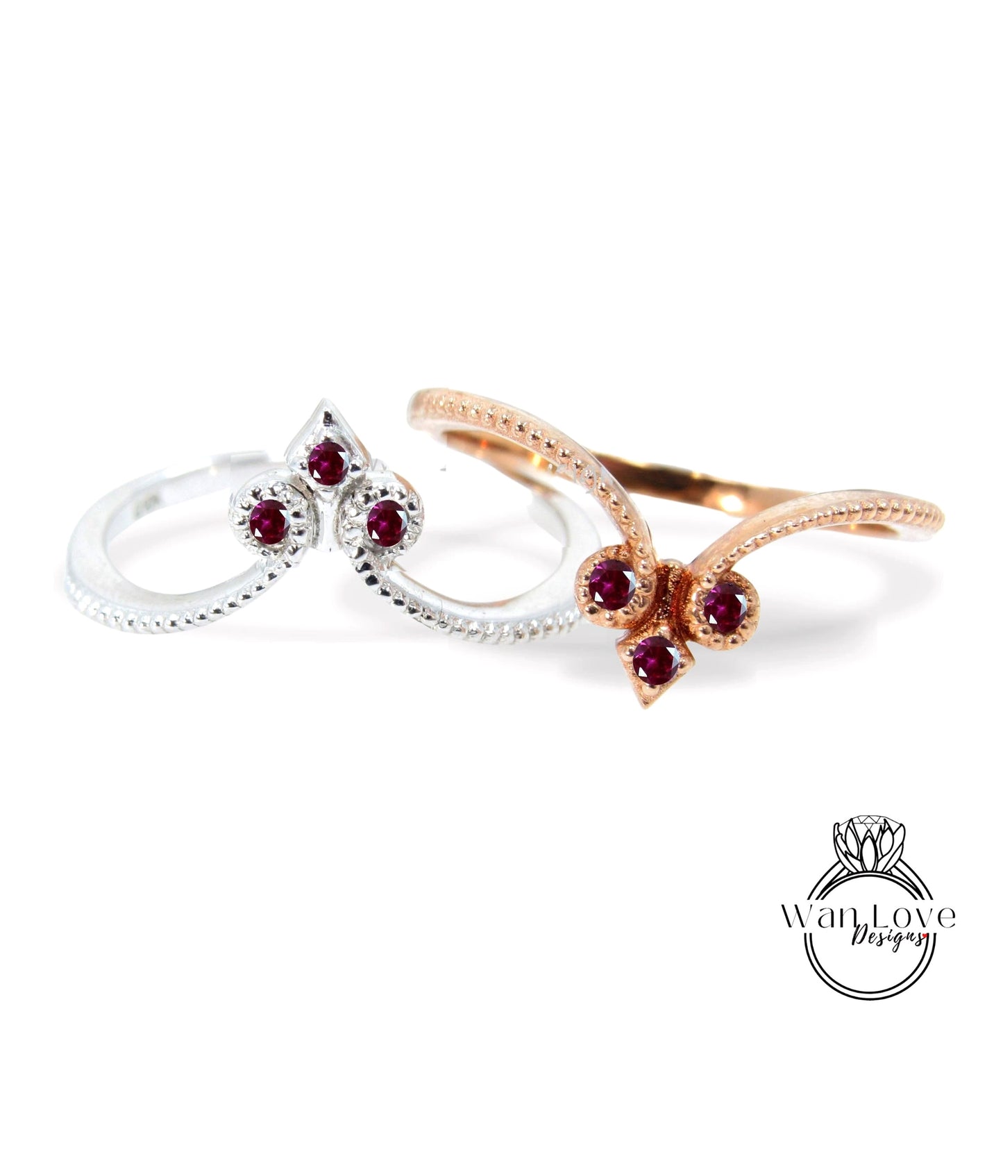 two rings with gemstones, one silver and one gold, against a white background.