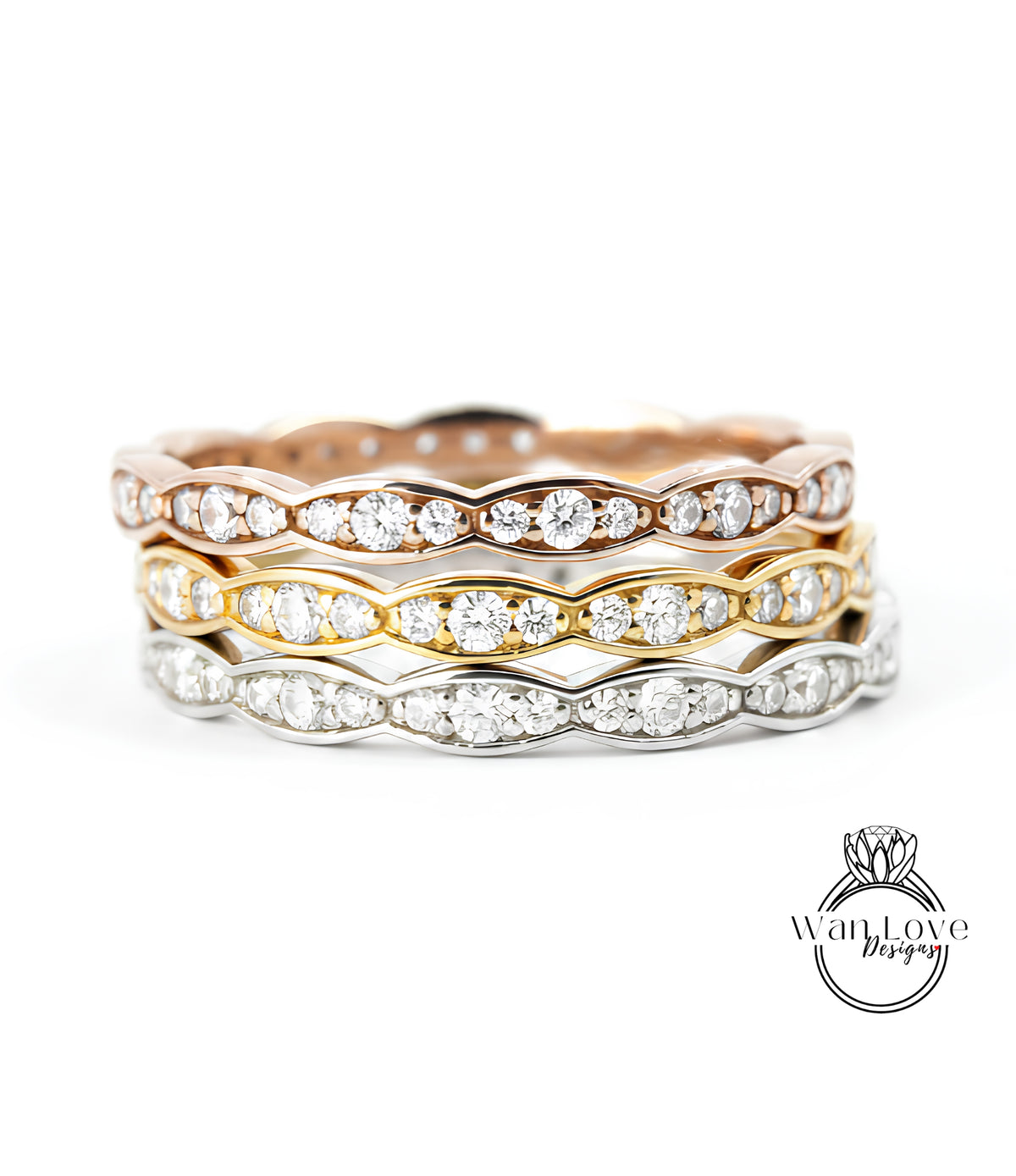 A stack of three rings with diamond-encrusted bands, showcasing the rings in various colors and designs.