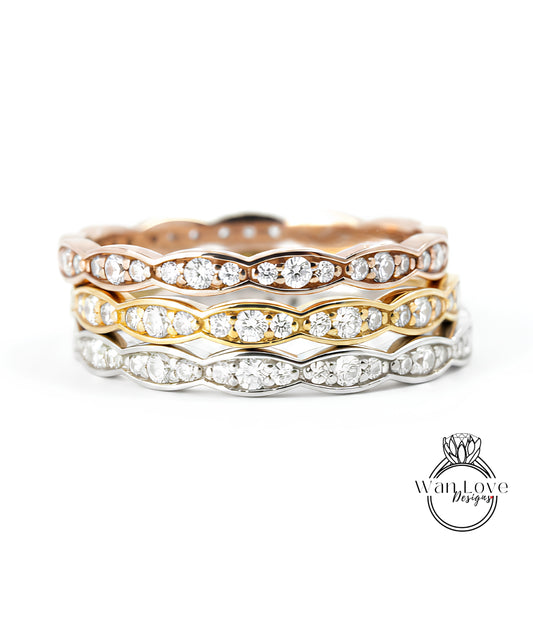 A stack of three rings with diamond-encrusted bands, showcasing the rings in various colors and designs.
