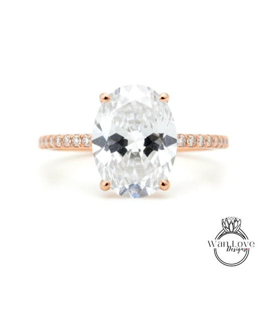 A close-up of a diamond engagement ring with a large oval-shaped diamond set in a rose gold band.