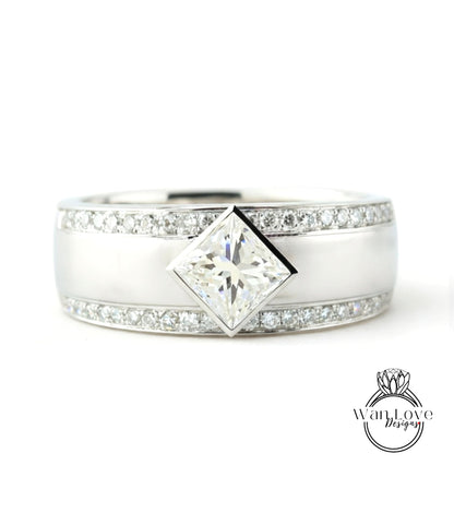A silver ring with a large diamond set in the center, surrounded by smaller diamonds along the band.