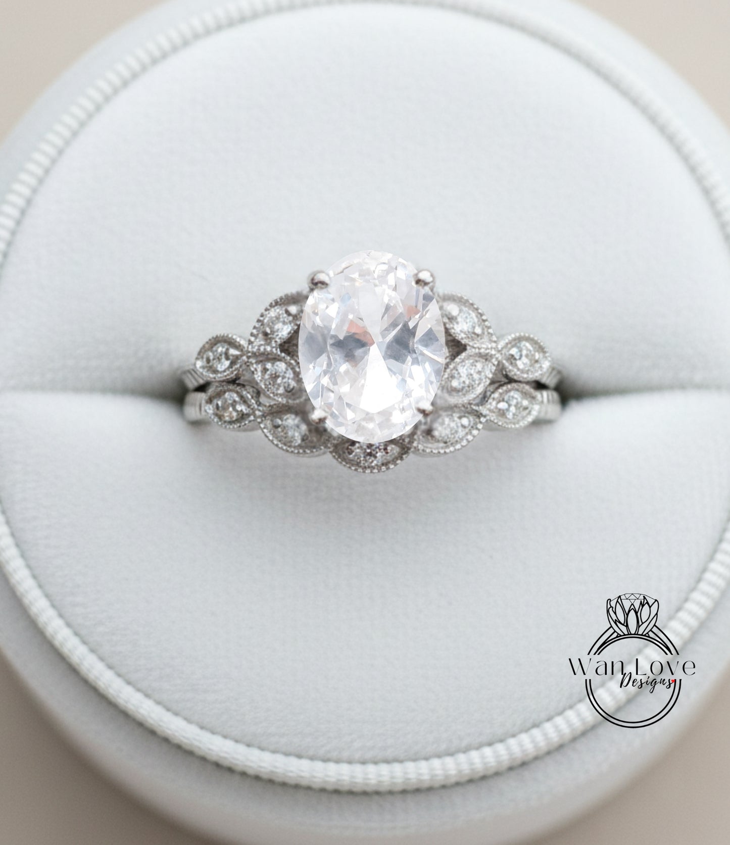 A close-up image of a diamond engagement ring displayed in a white jewelry box.