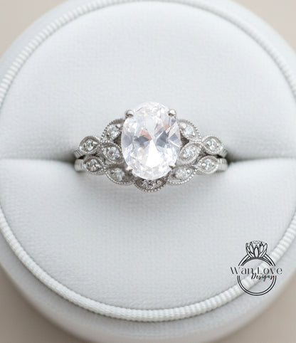A close-up image of a diamond engagement ring displayed in a white jewelry box.