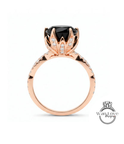 A rose gold ring with a large black gemstone, likely a diamond, at the center.