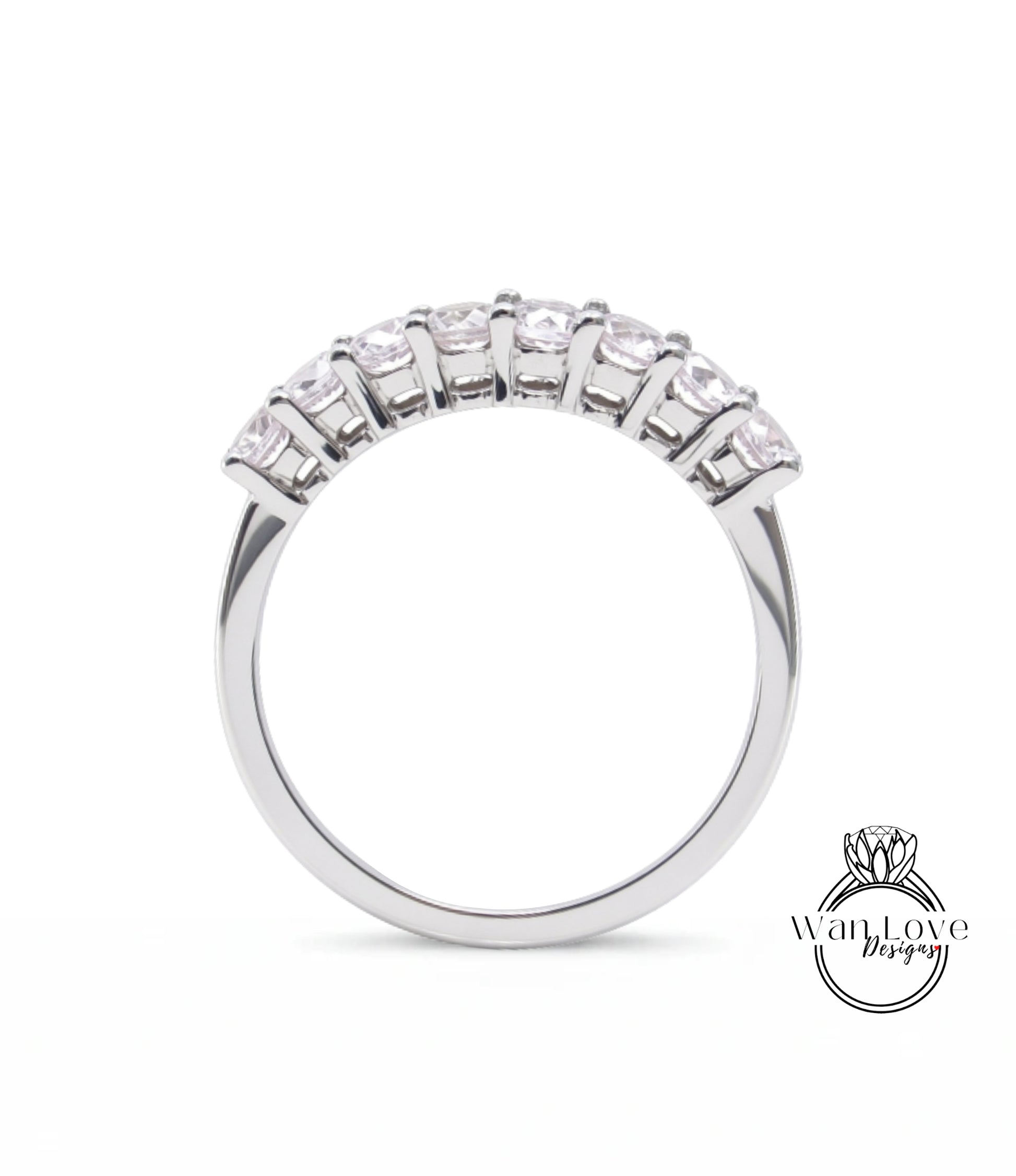 A silver ring with a row of small diamonds set in the band.