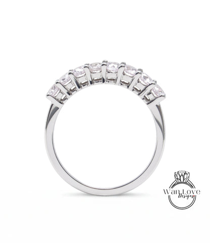 A silver ring with a row of small diamonds set in the band.