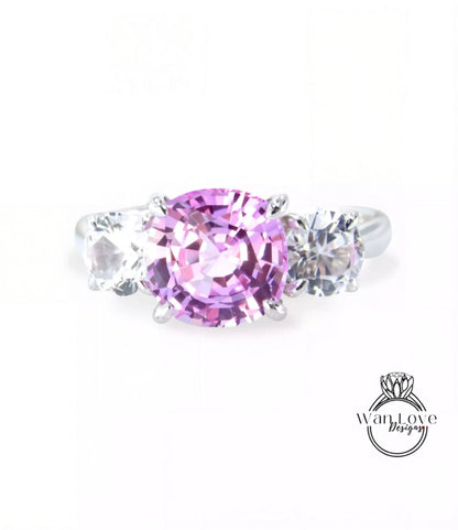 A ring with a large pink gemstone surrounded by smaller clear gemstones.