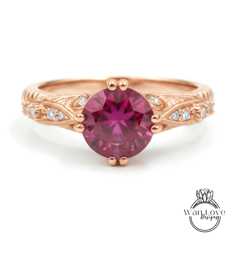 a beautiful pink gemstone ring with an intricate design around the band.