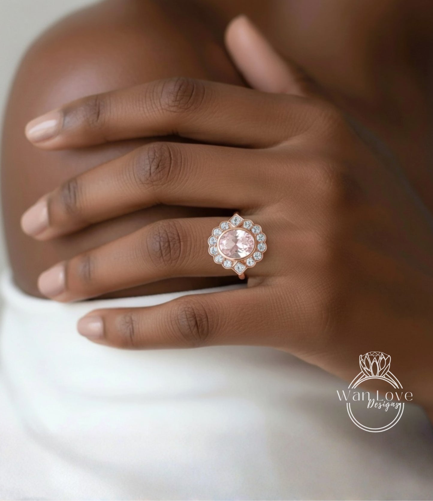 A close-up of a person's hand wearing a large, ornate ring with a pink gemstone.