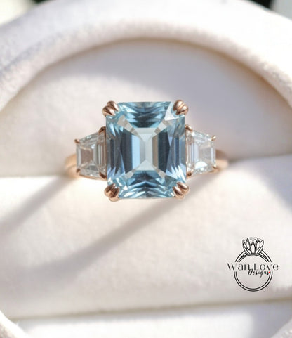 A close-up image of a gold ring with a large blue gemstone, showcasing the intricate details and craftsmanship of the jewelry.