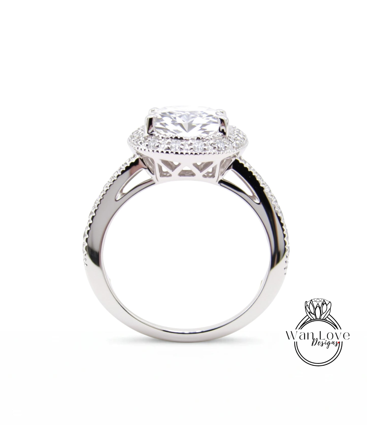 A close-up view of a silver engagement ring with a large central diamond surrounded by smaller diamonds, set in a halo of smaller diamonds.